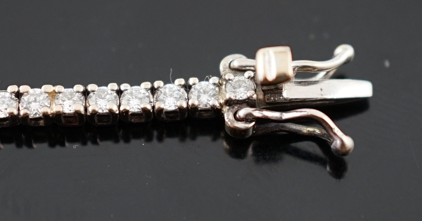 A modern 18ct white gold and diamond set line bracelet
